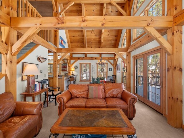 carpeted living room with beamed ceiling, an inviting chandelier, high vaulted ceiling, and wooden ceiling