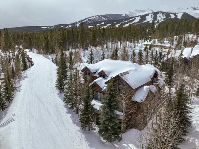 snowy aerial view with a mountain view