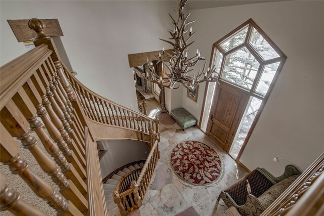 entrance foyer featuring a towering ceiling and a notable chandelier