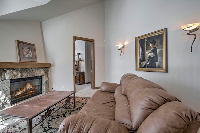 carpeted living room featuring a fireplace and lofted ceiling