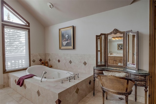 bathroom featuring tile patterned floors, a relaxing tiled tub, and vaulted ceiling