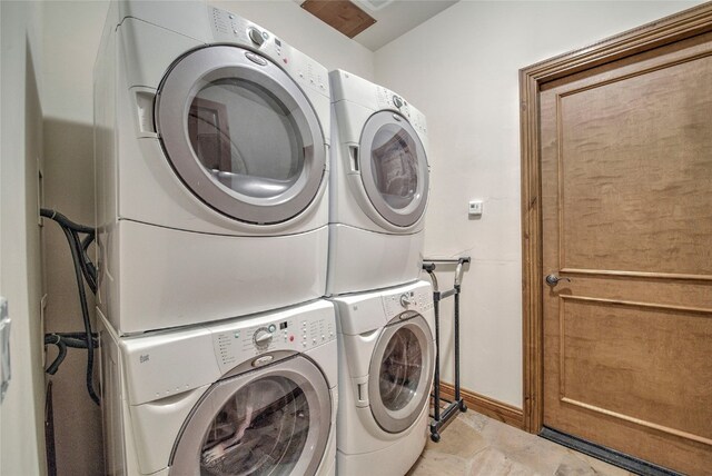 washroom featuring stacked washer and clothes dryer