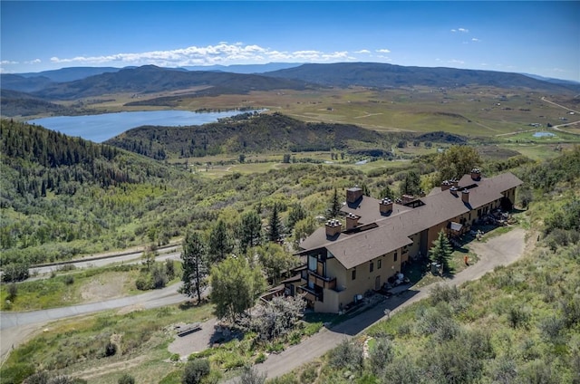 drone / aerial view with a water and mountain view