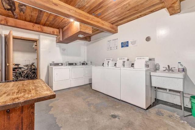 laundry area featuring sink, wooden ceiling, and washing machine and clothes dryer