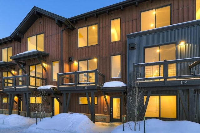 snow covered property featuring board and batten siding