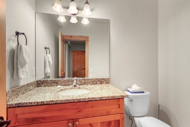 bathroom with toilet and vanity