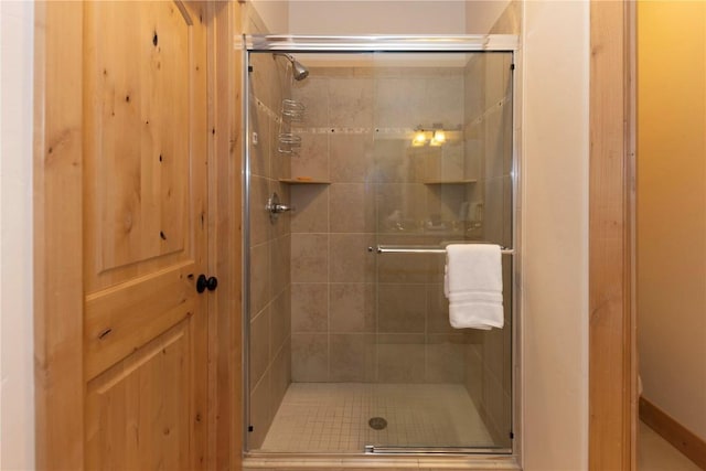 bathroom with a shower with shower door