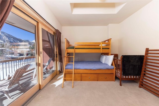 bedroom with a mountain view and light carpet