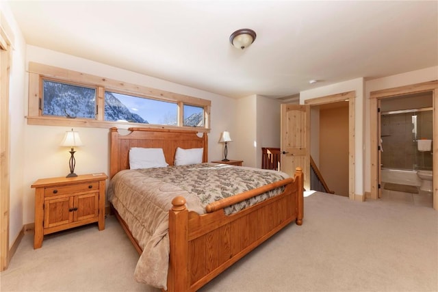 carpeted bedroom featuring connected bathroom