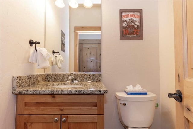 bathroom with toilet and vanity