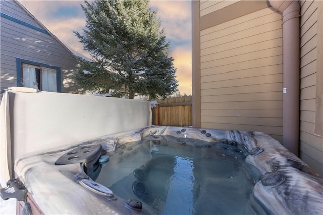 patio terrace at dusk with a hot tub