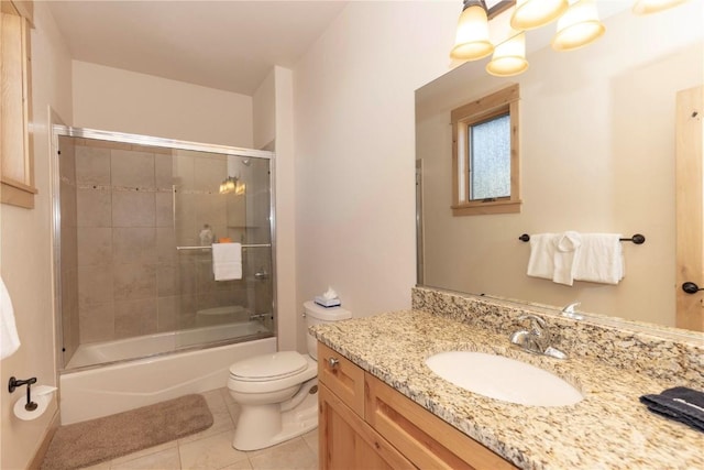 full bathroom with toilet, bath / shower combo with glass door, vanity, and tile patterned floors