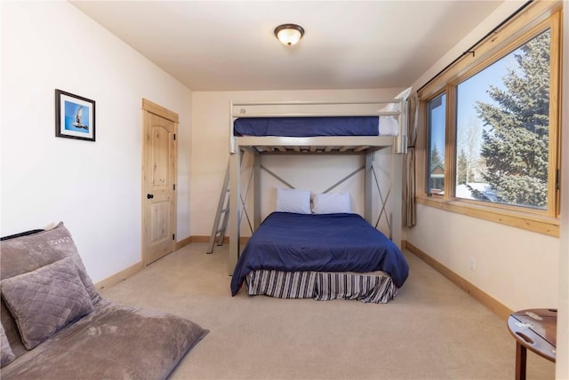 bedroom with light carpet and multiple windows