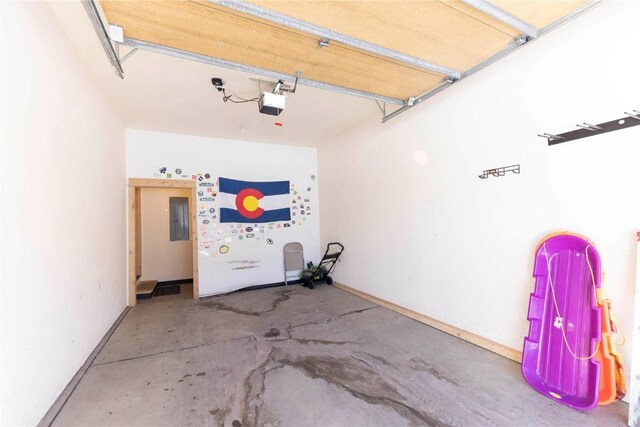 garage featuring electric panel and a garage door opener