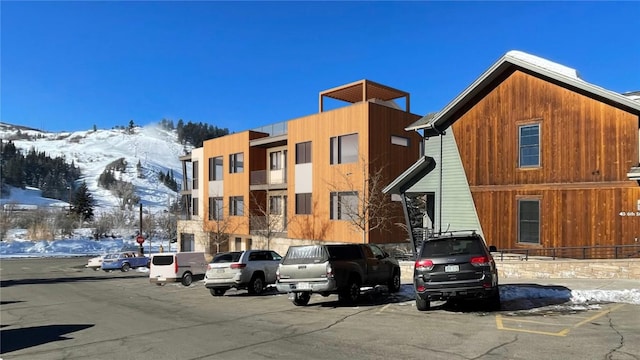 snow covered building featuring a mountain view