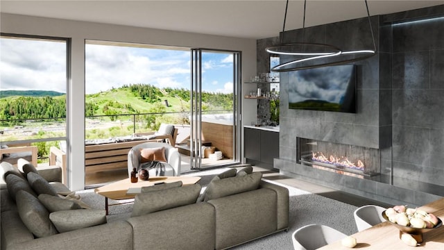 living room featuring a tile fireplace and plenty of natural light