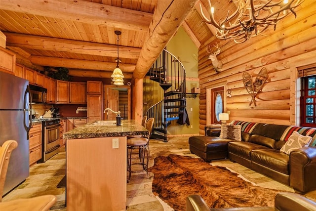 living room with rustic walls, sink, an inviting chandelier, beamed ceiling, and wood ceiling