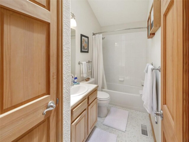 full bathroom with tile patterned flooring, shower / bath combo, toilet, and vanity