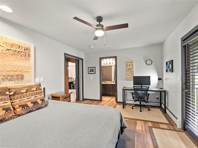 bedroom featuring connected bathroom, ceiling fan, and light hardwood / wood-style flooring