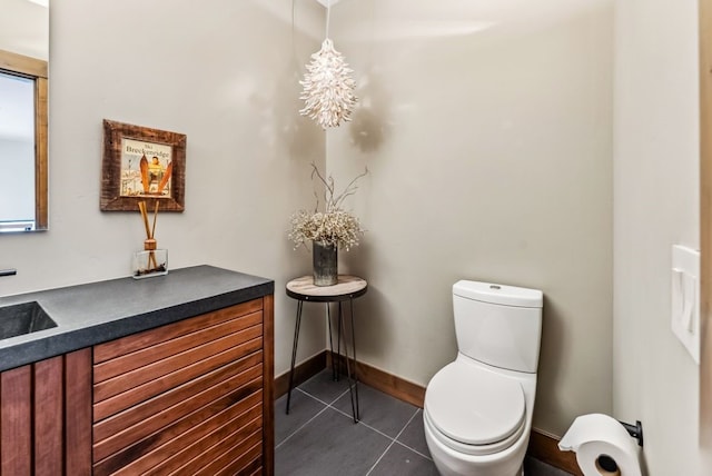 bathroom featuring tile patterned flooring, vanity, and toilet