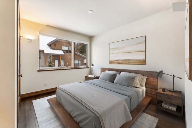 bedroom with dark hardwood / wood-style flooring