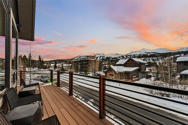 snow covered deck featuring a mountain view