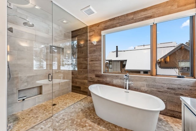 bathroom featuring vanity, a healthy amount of sunlight, and shower with separate bathtub