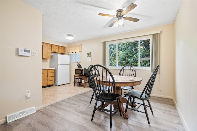 tiled dining room with ceiling fan