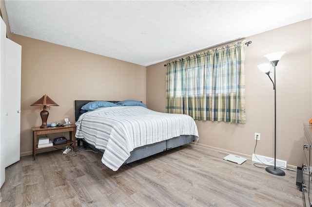 bedroom with hardwood / wood-style floors