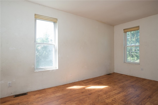 unfurnished room with wood-type flooring