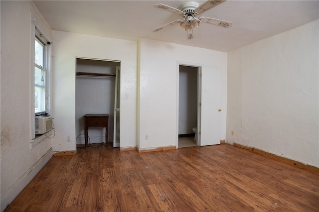 unfurnished bedroom with ceiling fan, dark wood-type flooring, and a closet