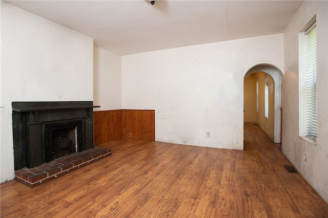 unfurnished living room with dark hardwood / wood-style flooring and a fireplace