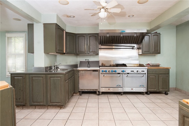 kitchen featuring ceiling fan, dark brown cabinets, sink, and light tile flooring