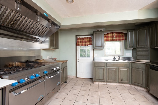 kitchen with appliances with stainless steel finishes, custom range hood, sink, and light tile flooring