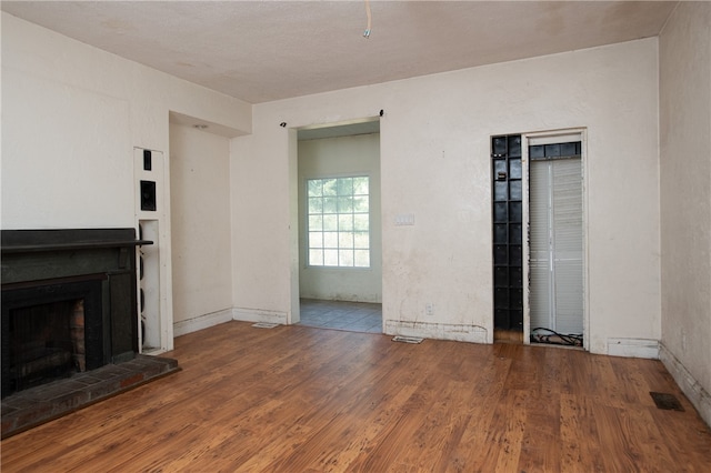 unfurnished living room with hardwood / wood-style flooring