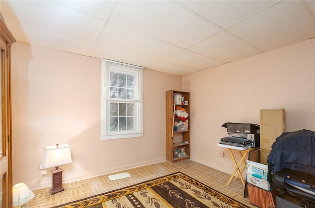 office area with light parquet flooring and a paneled ceiling