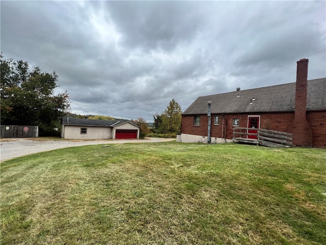 view of yard featuring an outbuilding and a garage