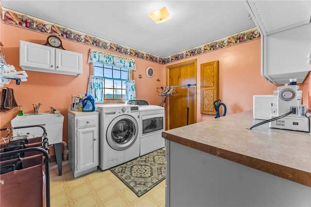 laundry area featuring cabinets, independent washer and dryer, and light tile floors