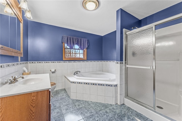 full bathroom featuring independent shower and bath, tile walls, oversized vanity, toilet, and tile floors