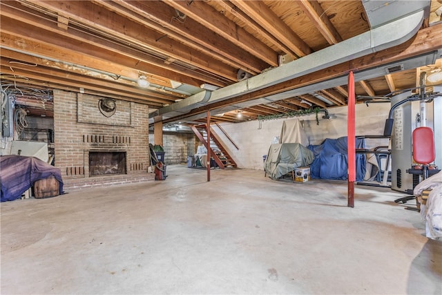 basement with a fireplace and brick wall