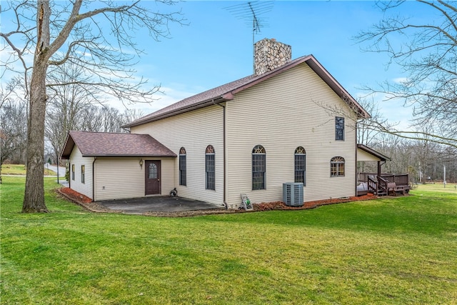 back of house featuring central AC, a yard, a patio area, and a wooden deck