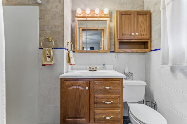 bathroom featuring vanity, tasteful backsplash, toilet, and tile walls