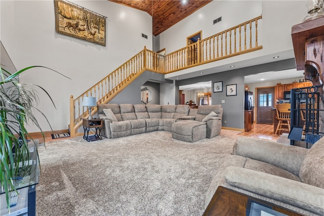 living room featuring high vaulted ceiling, wooden ceiling, and light wood-type flooring