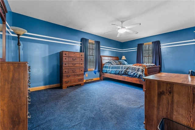 unfurnished bedroom featuring dark colored carpet and ceiling fan