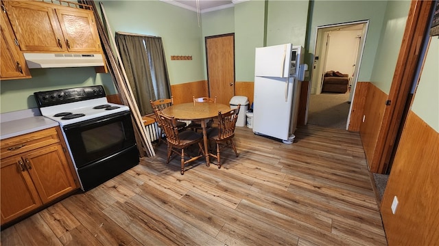 kitchen with light hardwood / wood-style flooring, white appliances, and ornamental molding