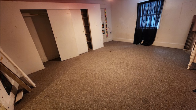 unfurnished bedroom featuring dark colored carpet and a closet