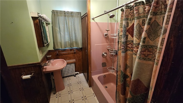 bathroom featuring radiator, tile floors, and shower / bath combo with shower curtain