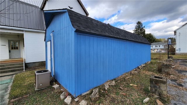 view of side of home with central AC