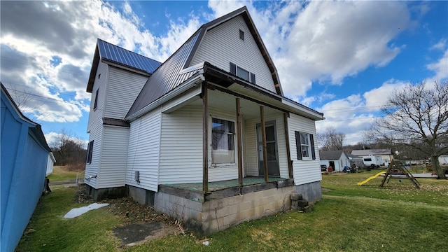 rear view of property with a yard