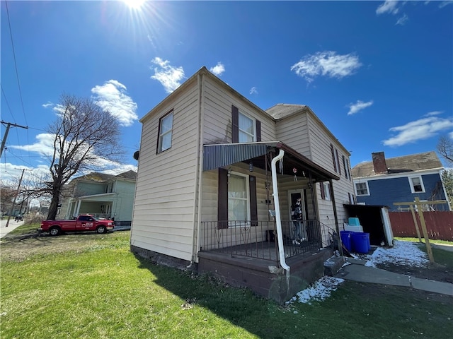 view of front of home with a porch and a front yard